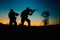 Silhouette of military soldiers with weapons at night. shot, holding gun, colorful sky. .