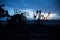 Silhouette of mobile air defence truck with radar antenna during sunset. Satellite dishes or radio antennas against evening sky