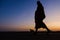 Silhouette of monk feet walking on concrete ground for people of