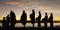 Silhouette of monks during reception of alms, on the shore of the mekong river