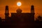 A silhouette of a mosque at sunrise vivid color