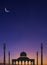 Silhouette Mosques Dome and towers with Crescent Moon on dark blue Twilight sky in vertical frame