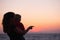 Silhouette of mother with baby in sunset on beach