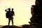 Silhouette of mother and son boy see sunaet at beach