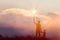 Silhouette of mother and son christian prayers raising cross while praying to the Jesus on sunset background