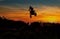 silhouette of motor cross rider jumping on the mountain in sunrise