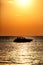 Silhouette of a motor speed boat at sunset