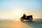 Silhouette a motorbike stands on the beach