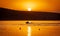 Silhouette of motorboat on the river at summer sunset