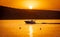 Silhouette of motorboat on the river at summer sunset