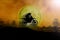 Silhouette of motorcycle jump in sky with the moon. Elements of this image furnished by NASA.