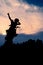 The silhouette of a motorcyclist at sunset.