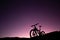 Silhouette of Mountain Bike, Dirt bike on the car roof rack in the countryside at the sunset,Bicycles built for traveling on dirt