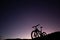 Silhouette of Mountain Bike, Dirt bike on the car roof rack in the countryside at the sunset,Bicycles built for traveling on dirt