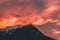 Silhouette of the mountain peak captured under the vibrant clouds in the sky at sunset