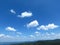 Silhouette of mountains in Bulgaria in summer and many white clouds in the blue sky. Mountainous view.