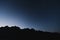 Silhouette mountains ridge, with clear sky full of star in dawn