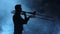 Silhouette musician man playing on trombone. Smoky studio, slow motion