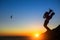 Silhouette of musician play Tuba on sea shore at sunset . Romance.