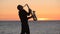 The silhouette of a musician playing saxophone on
