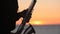 The silhouette of a musician playing saxophone on