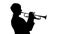 Silhouette. Musician slowly playing trumpet in a studio