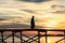 Silhouette Muslim man walk on the wooden jetty