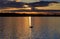 Silhouette of Mute Swan, Clouds and sunset reflected in the ripples of Ravensthorpe reservoir