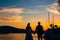 Silhouette of a newlywed couple on the background of the setting sun