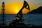 Silhouette of oil derricks on a sunset background. Oil and gas production concept. With place for your text