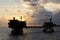 Silhouette of oil production platforms at Terengganu oil field during sunset