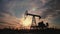 Silhouette of oil pump at sunset