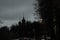 Silhouette of the old church against the background of the evening sky. Tree silhouettes.