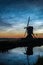 Silhouette of an old dutch windmill against a sky with noctilucent clouds NLC around midnight