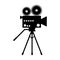 Silhouette of an old movie camera on a tripod. Icon, silhouette, sign. Vector illustration.