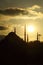 Silhouette of the old town - Sultanahmet mosques in setting sun in Istanbul Turkey.