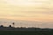 The silhouette of an old windmill on a farm in a golden sunset. Barker in Uruguay