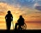 Silhouette of an old woman on crutches and elderly man in a wheelchair