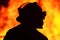 Silhouette one fireman officer front fire flames