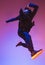 The silhouette of one hip hop male break dancer dancing on colorful background