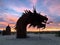 Silhouette of an outdoor Serpent Sculpture during a colorful sunrise