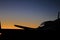 SILHOUETTE OUTLINE OF A GRIPEN JET AGAINST THE DAWN