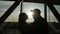 Silhouette of pair of lovers near the window in airport