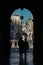 The silhouette of a pair of tourists in front of St. Mark`s Cathedral in Venice.