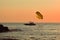 Silhouette of a parachute boat at sunset