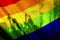 silhouette of a parade of gays and lesbians with a rainbow flag - symbol of love and tolerance