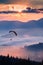 Silhouette of paraglider in the air