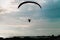 Silhouette paraglider flying on the sea in turquoirs sky background.