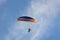 Silhouette of paraglider soaring at sunset