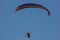 Silhouette of paraglider soaring at sunset